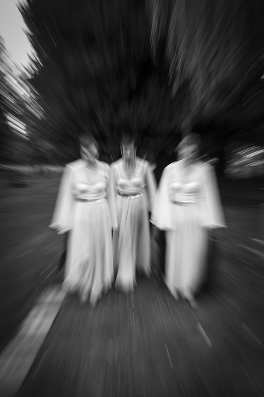 blurred image of three women walking in the cemetery